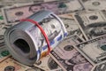 Close Up Roll of One Hundred US Dollar Bills Secured with Red Rubber Band Royalty Free Stock Photo