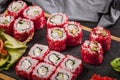 Close-up roll-set with salmon meat with rice in red flying fish roe. Pickled ginger, spicy wasabi paste and soy sauce Royalty Free Stock Photo