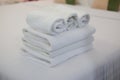 Close up roll of white towel on the bed Royalty Free Stock Photo