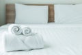 Roll of white towel on the bed table in Luxury modern hotel room Royalty Free Stock Photo