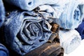 Close up rolled of blue jeans pants, dark blue denim trousers showing texture on white Royalty Free Stock Photo