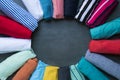 Close up of rolled colorful clothes on black background