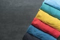 Close up of rolled colorful clothes on black background