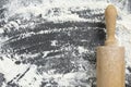 Close up of rolling pin on wheat flour background