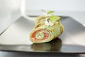 Close up of rolls with spinach pancake, salmon and cream cheese. Food delivery and catering concept