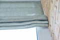 Close-up of roman blinds with gray linen fabric