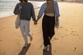 Close up of romantic couple in love is walk holding hands across the sunny beach Royalty Free Stock Photo