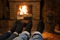 Close up of romantic legs in socks in front fireplace Royalty Free Stock Photo