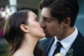 Close up of romantic newlywed couple kissing in park Royalty Free Stock Photo