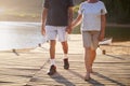 Close Up Of Romantic Senior Couple Walking On Jetty By Lake Royalty Free Stock Photo