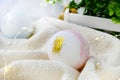 Close up romantic spa composition. Bath bomb on towel. Aromatherapy or health care concept