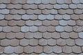Close-up of a roof in flat grey tiles with rounded ends