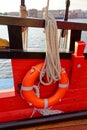 Close up of a rope and lifebuoy on a old wooden ship. Details deck of the saiilboat Royalty Free Stock Photo