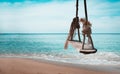 Close up rope Swing plank Benches for relaxation on the sand. Royalty Free Stock Photo