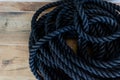 a close up of a rope on a wooden floor with wood boards Royalty Free Stock Photo