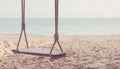 Close-up of Rope wooden swing hanging on tree at topical beach with sunlight