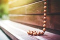 close-up of a rosary on a church wooden pew