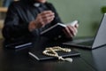 Close up of rosary on workplace desk with unrecognizable priest in background