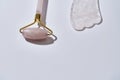 Close up of rose quartz massage roller and gua sha scraper. Facial skin care at home Royalty Free Stock Photo