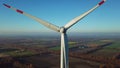 Close up of rotating wind turbine zooming out