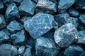 Close-up of rough blue stone texture, rugged, uneven surface with speckles of darker hues. Royalty Free Stock Photo