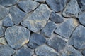 Close-up of rough blue stone texture, rugged, uneven surface with speckles of darker hues. Royalty Free Stock Photo