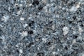 Close-up of rough blue stone texture, rugged, uneven surface with speckles of darker hues. Royalty Free Stock Photo
