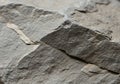 Close-up of a rough, gray stone surface featuring layers and fractures. The texture is Royalty Free Stock Photo