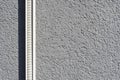 Grey Textured Wall with White Plastic Cable Trunking Royalty Free Stock Photo