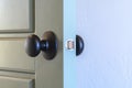 Close up of a round black door knob installed on a gray paneled interior door Royalty Free Stock Photo
