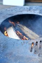 A close-up of the round frying surface with burning wood inside Royalty Free Stock Photo