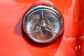 Close-up of the round headlight of a bright red classic car in Manchester, the United States Royalty Free Stock Photo