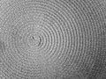 Close-up of a round modern wicker gray wicker tablecloth background. Circle carpet Royalty Free Stock Photo