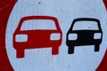 Close up of round old isolated scratched no passing sign with red and black car Royalty Free Stock Photo