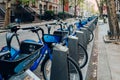 Close up of row of Citi Bikes parked at the docks on a street in Manhattan, New York, USA