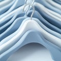 Close Up of a Row of Empty Blue and White Plastic Clothes Hangers on a Blue Background. Royalty Free Stock Photo