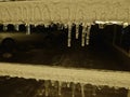 Close up on a row of icicles on a building in winter