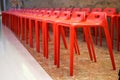 Close-up of a row of red high stools indoors Royalty Free Stock Photo