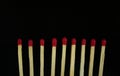 Close up row of red matches isolated on black background with copy space Royalty Free Stock Photo