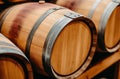 Close up of a row of wooden wine barrels in a cellar Royalty Free Stock Photo