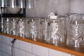 Close up of Rows of clean empty wine, beer , water glasses in loft restaurant natural light