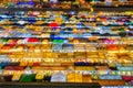 Close-up of rows of colorful market tents and food stalls at night.