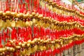 Close up rows Devotees hanging golden prayer bells for blessing at at Wong Tai Sin Temple, Hong Kong Royalty Free Stock Photo