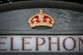 Close up of a royal crown symbol on an english grey phone booth in Bath UK
