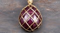 Close-up of a ruby gemstone pendant with gold wire cage setting Royalty Free Stock Photo