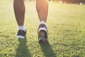 close up runer leg running on grass with sunset