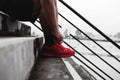 Close-up runner tying shoelace on the steps, healthy lifestyle Royalty Free Stock Photo