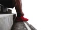 Close up runner tying shoelace on the steps, isolated on white background with copy space, healthy lifestyle Royalty Free Stock Photo