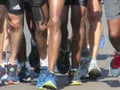 A close up of runners legs in road running race