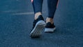 Close up of running shoes and legs woman walking on the street Royalty Free Stock Photo